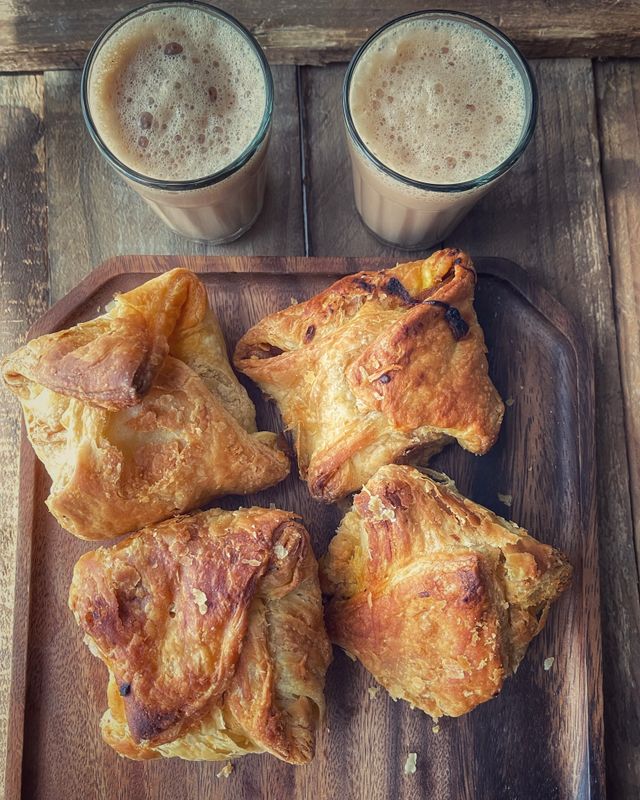 Golden puff pastries on a serving tray